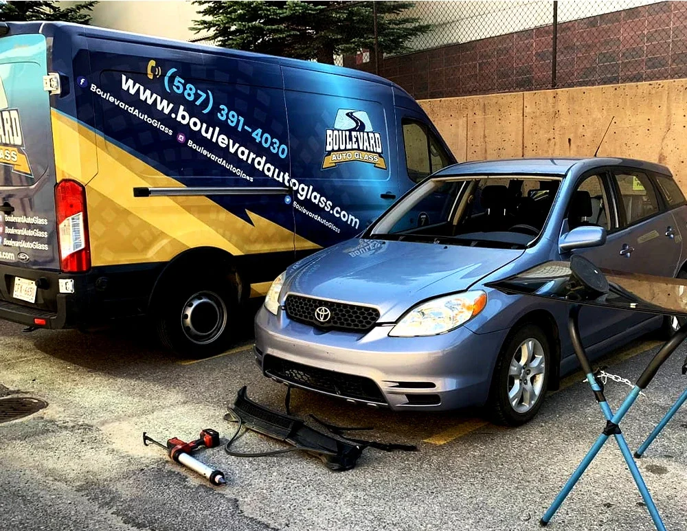 Boulevard auto glass mobile windshield replacement van parked beside a car to be serviced